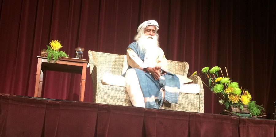 Sadhguru meditates on stage, drawing in a sold-out crowd.