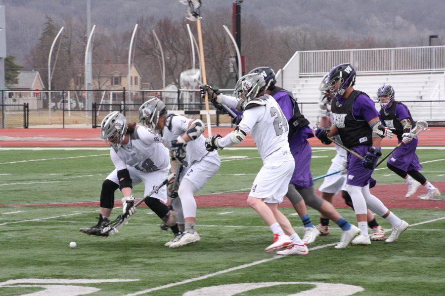 The UW-L Mens Lacrosse team fights for possession against Winona