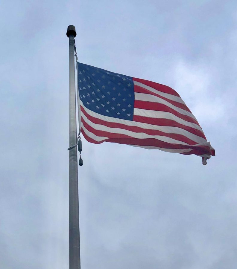 United States flag waves in the wind on the campus of University of Wisconsin-La Crosse