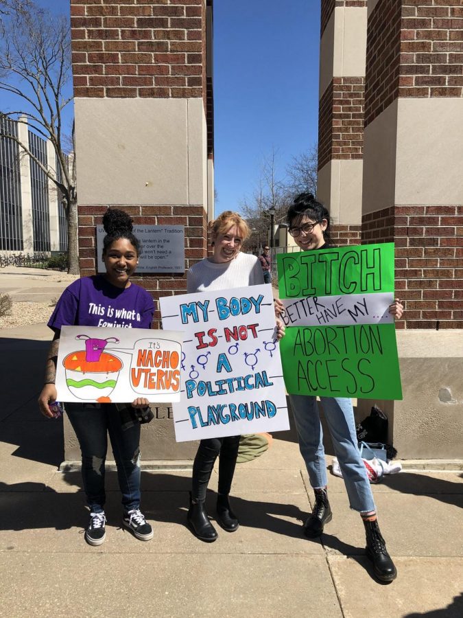 Gabriela Calderon, Emily Guttormsson, and MacKenzie Larson hold pro-choice signs
