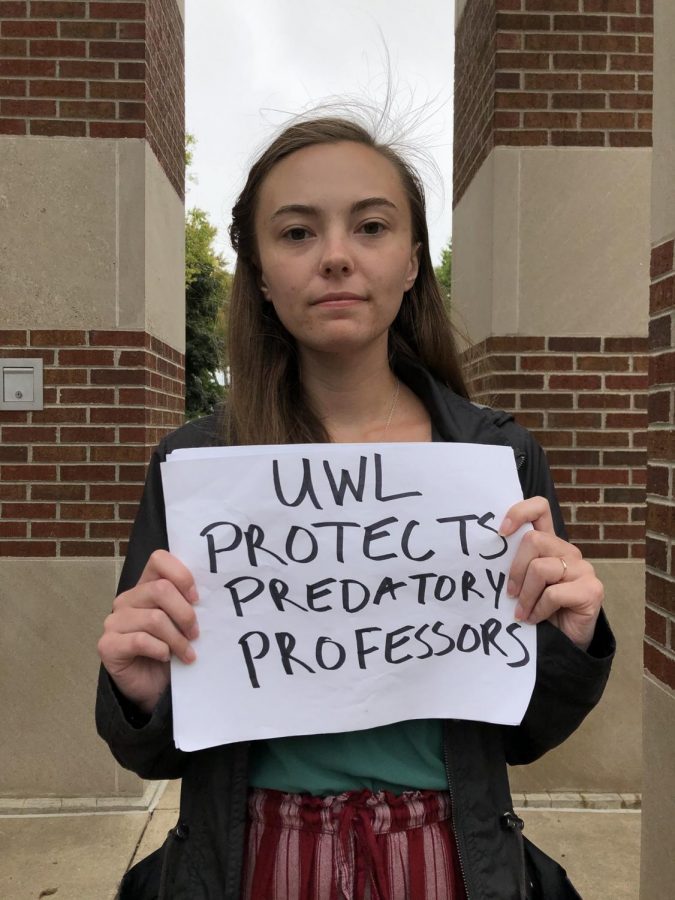 UWL student Kendra Whelan protests with a sign UWL Protects Predatory Professors.