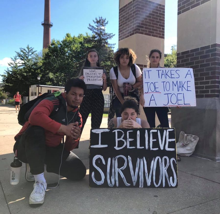 Back row (left to right): senior Kendra Elise Whelan, senior Migdalia Simpson and senior Bailey Click. Front row (left to right): UWL junior DeVonte Louis Kuykendall and Redington protest against sexual misconduct allegations on campus by the clock tower.