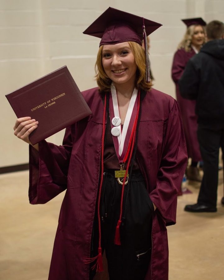 UWL student Karley Betzler holds her diploma after graduation.
