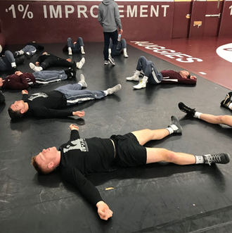 Wresting team practices mindfulness before their regional meet. 