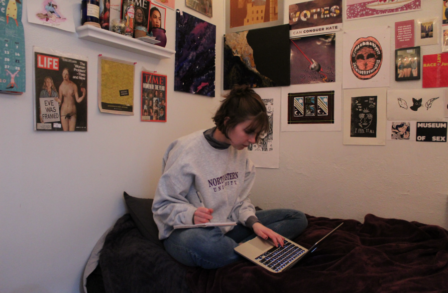 Sam Stroozas working on an article in her bedroom in La Crosse. 