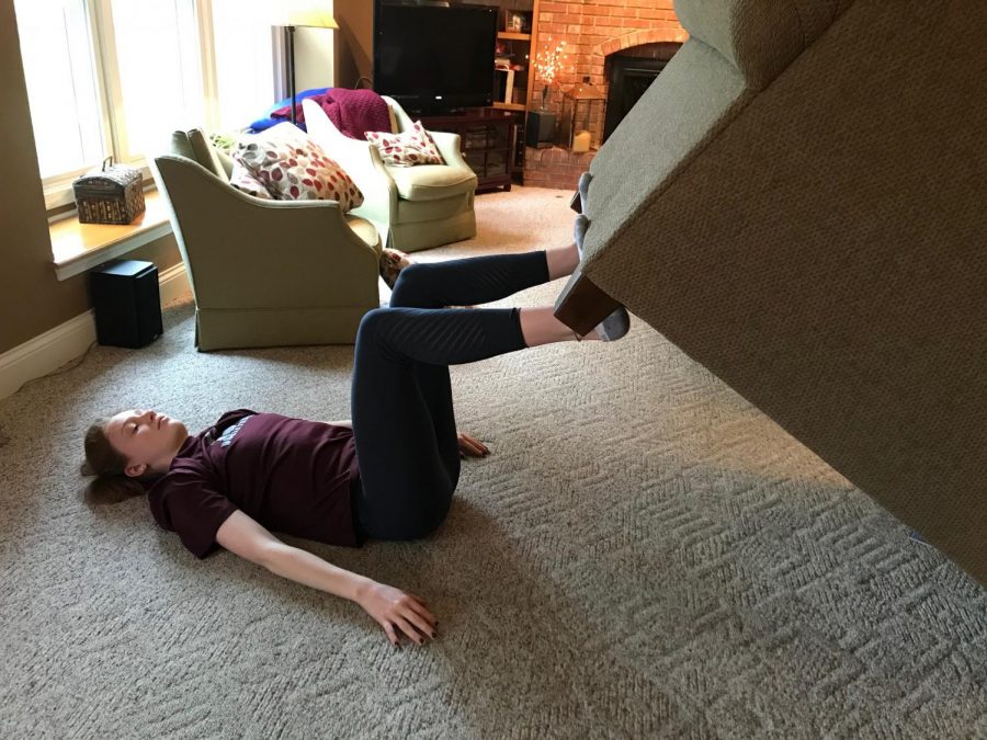 Lauren Young doing leg presses with her couch. Photo submitted by Lauren Young.