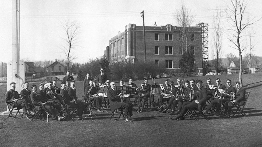 La Crosse Normal President Fassett E. Cotton, seated in the center, organized and led the school band. With many men headed to war, there weren’t enough interested from the Normal School in 1918 to form a band, so Cotton recruited young men from Central High School and formed a group of about 40 musicians. Here they are posing for a practice session in the spring on the campus grounds in front of the unfinished physical education building, which was eventually named Wittich Hall. While construction started on the building in 1916, it was stopped during WWI and the building opened in 1920. The university closed in mid-October 1918 due to the Spanish flu epidemic.