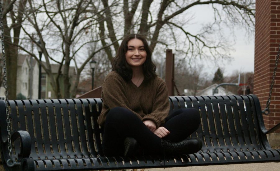 A photo of Julia Balli sitting on a bench.