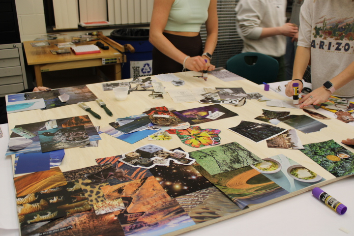 Students at the artist-led workshop glue cut out pictures onto a collage. Photo taken by Ann David. 