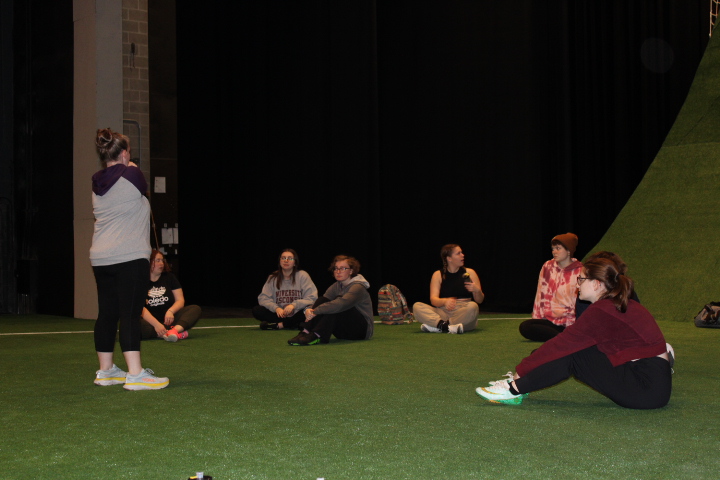 Director Mary Trotter organizes the cast before rehearsal. Photo taken by Ann David. 