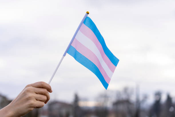 Transgender Flag hold in the sky. Photo retrieved from Getty Images. 