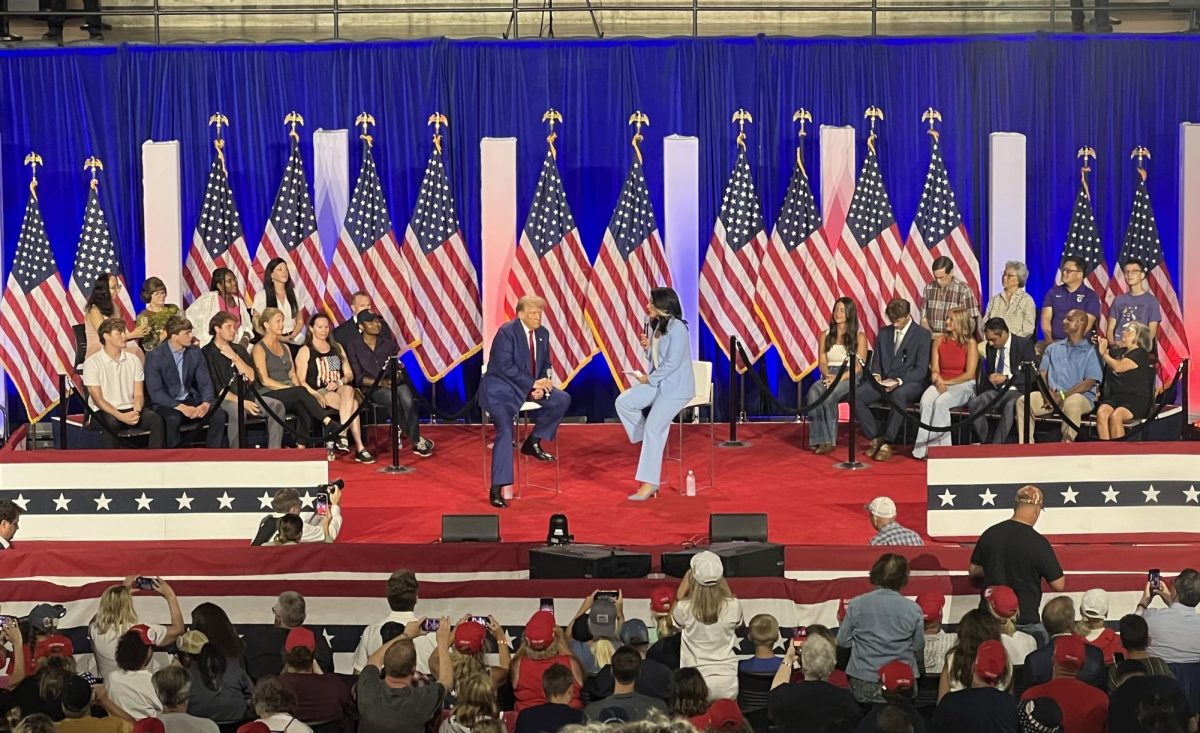 Former President Donald Trump on stage with event moderator Former member of Congress Tulsi Gabbard. (Picture taken by Isabel Piarulli.)