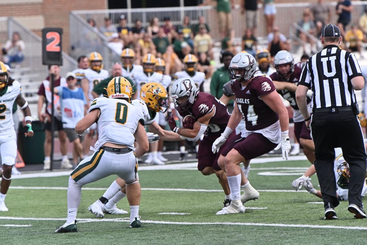 Gabe Lynch attempts to break a tackle. Photo taken by Jim Lund. 