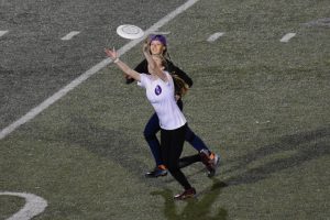 Maddie Schneider catching a deep pass while Jessica Barrett looks on. Photo by Paige Geiser. 