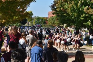 Parents and fans of the Screaming Eagles looking on as they parade through campus. Photo by Paige Geiser. 