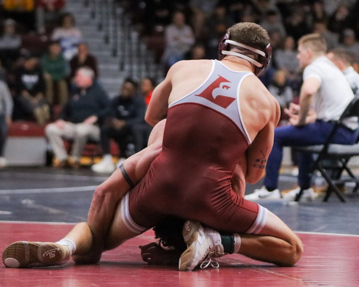 UWL Wrestler puts opponent in the front head position.