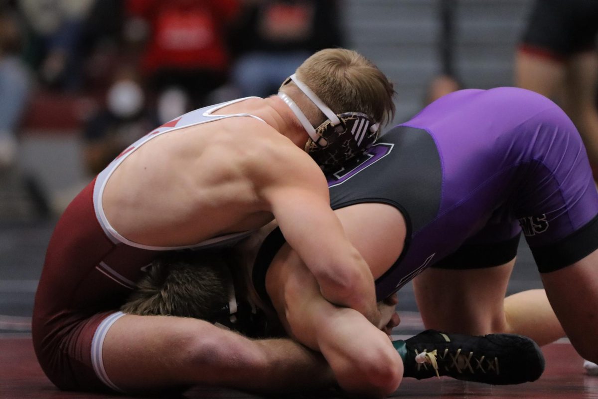 UWL Wrestler puts opponent in the front head position.