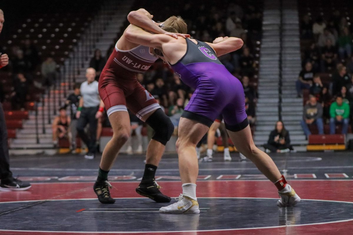 UWL Wrestler locked up with opponent.