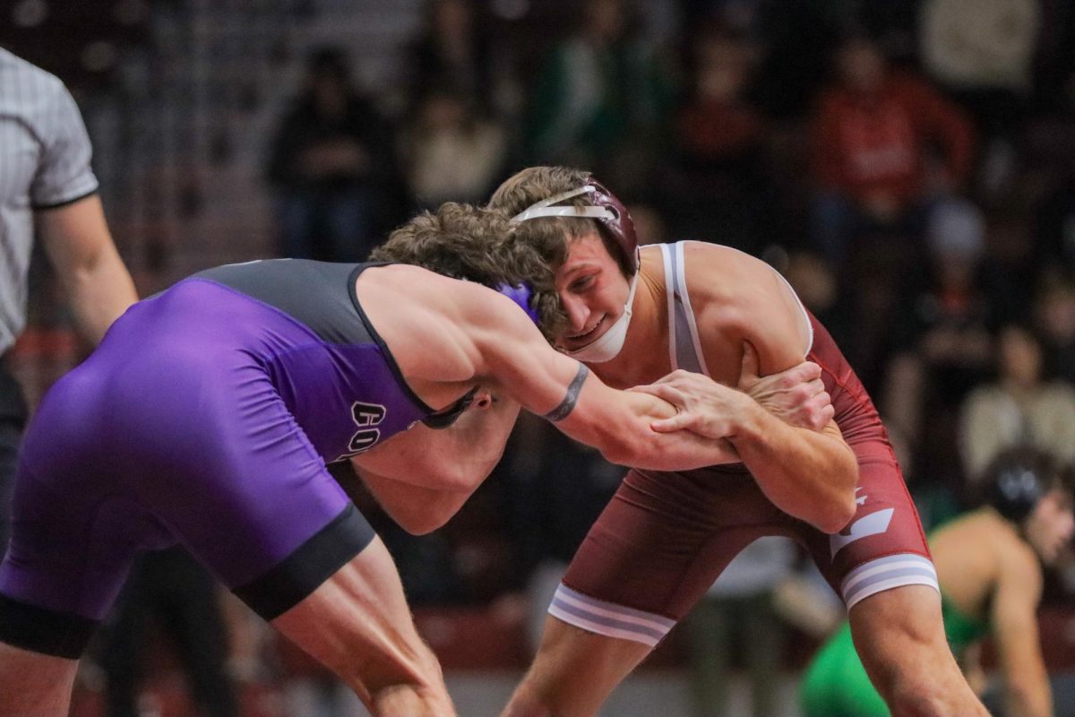 UWL Wrestler locked up with opponent.