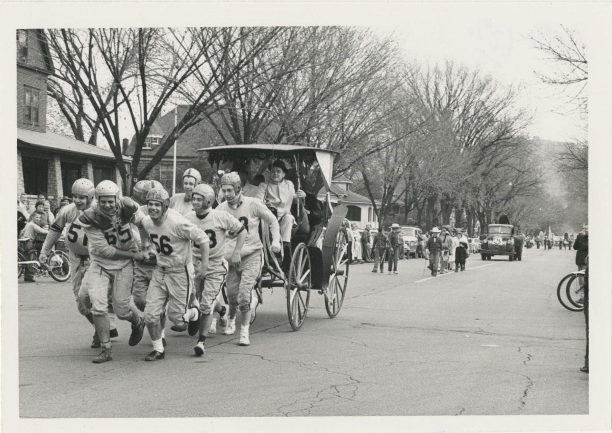 Football team during the parade, Homecoming circa 1920s or 1930s. Retrieved from UWL Murphy Library Special Collections/ARC. 