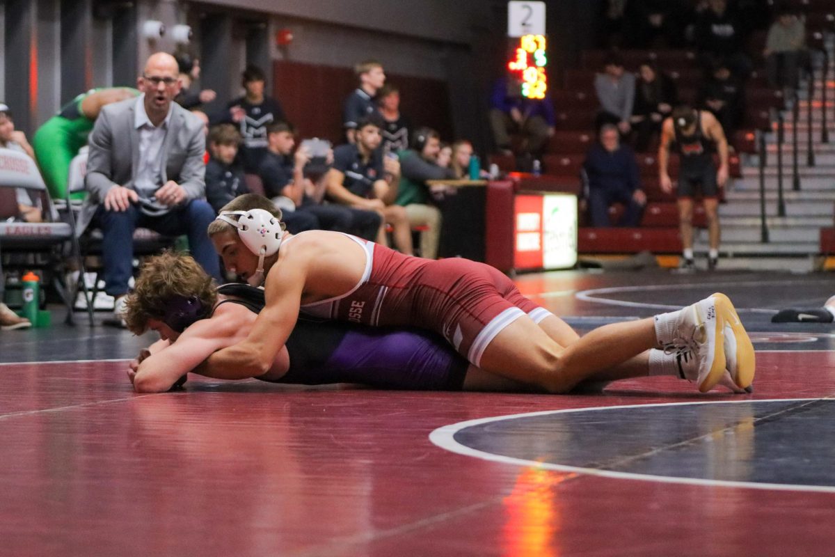 UWL Wrestler holds opponent on the mat.