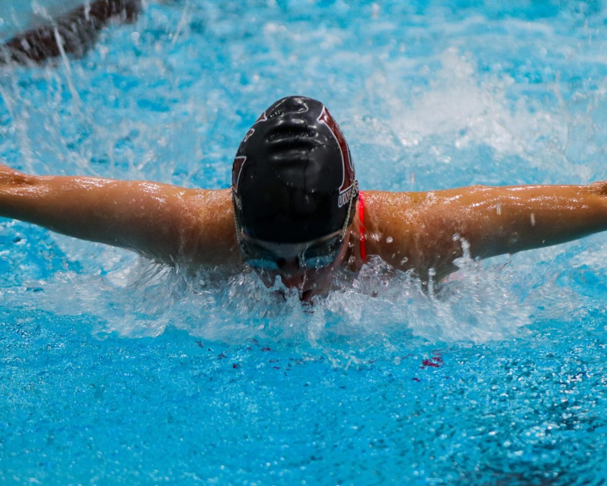 UWL swimmer competing in the butterfly. Photo by John Gaynor.