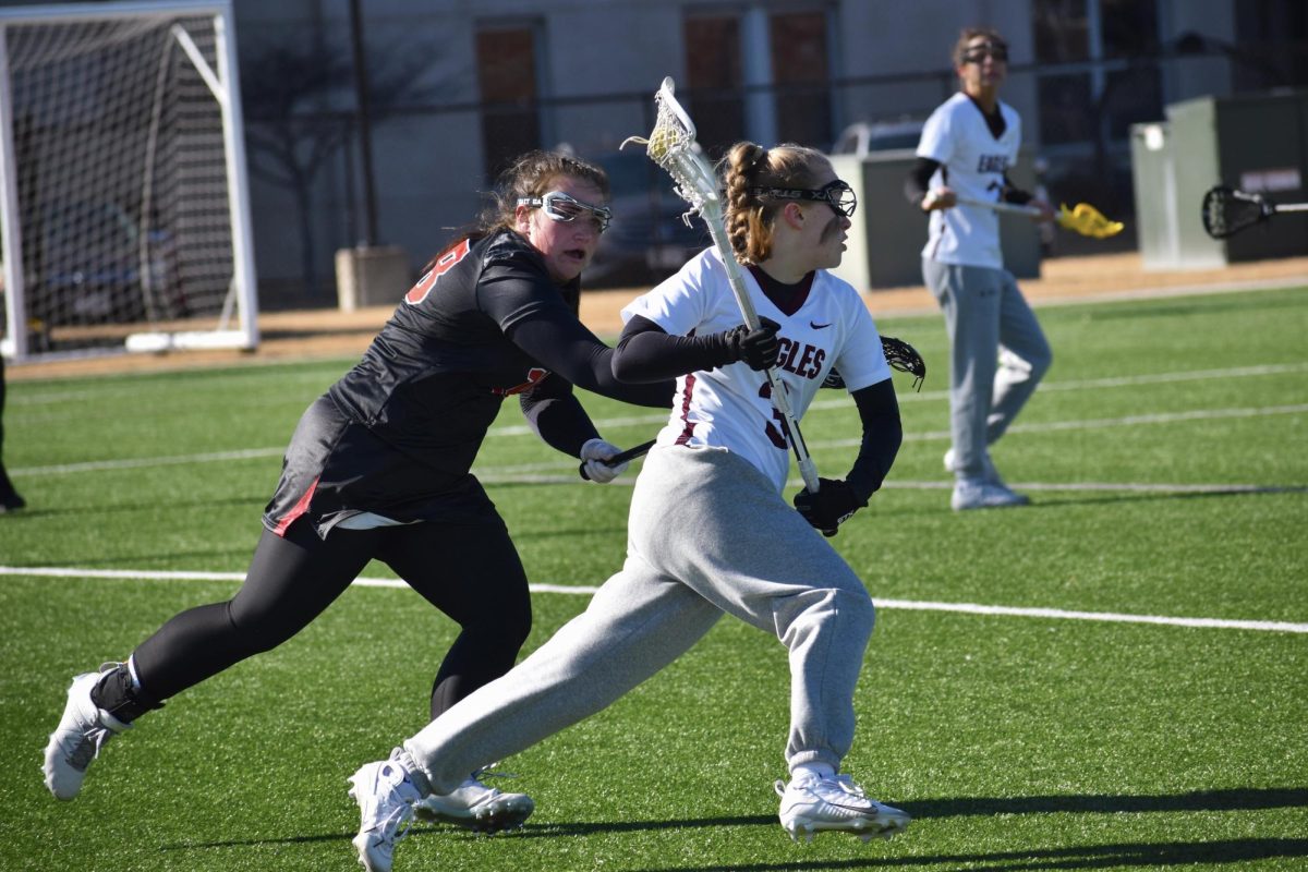 Joslyn Brotemarkle cradling the ball while evading a defender. Photo by Paige Geiser. 