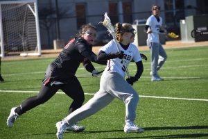 Joslyn Brotemarkle cradling the ball while evading a defender. Photo by Paige Geiser. 