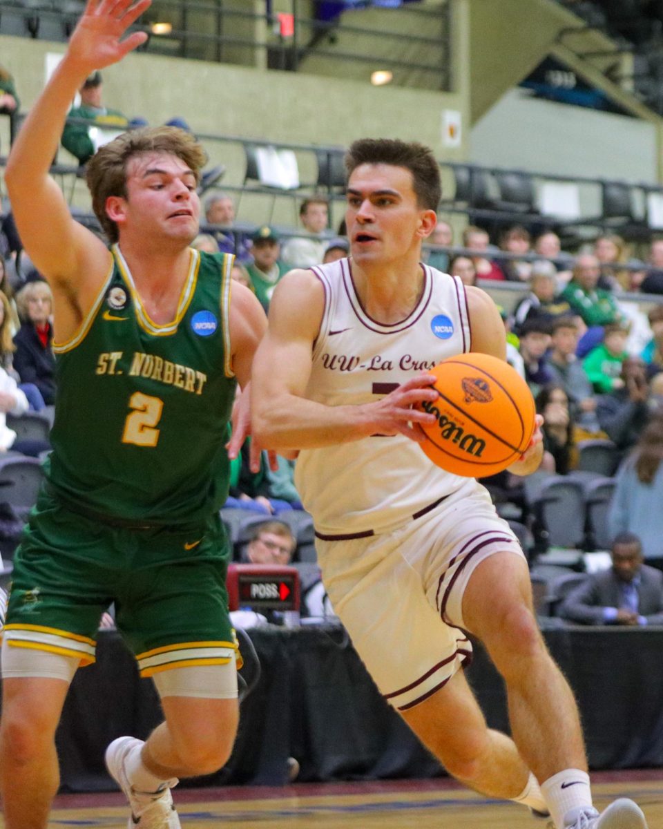 Will Fuhrmann drives to the basket during a game against St. Norbert College on Saturday, March 8th. Photo by John Gaynor. 