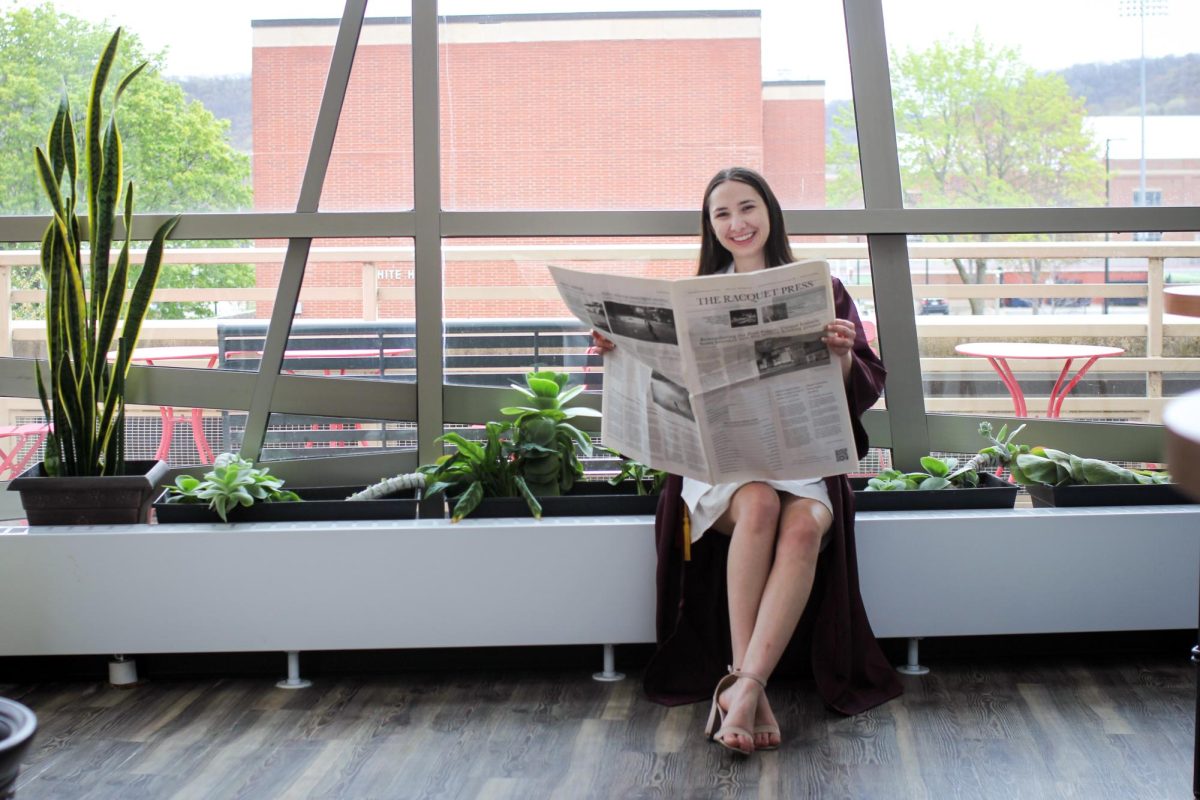Ann David holding The Racquet Press newspaper. Photo by Trinity Rietmann.