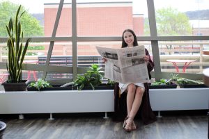 Ann David holding The Racquet Press newspaper. Photo by Trinity Rietmann. 