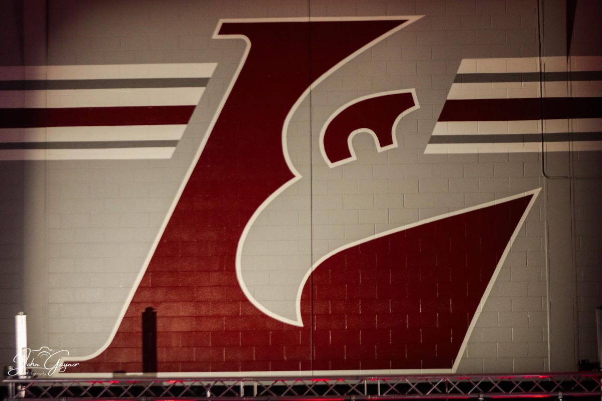 The UW-La Crosse logo lit up on the wall of Mitchell Hall. Photo by John Gaynor.