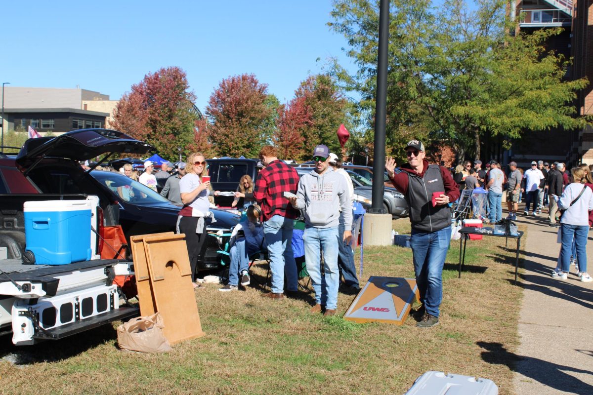 UWL fans playing cornhole before the game. Photo by Colin Cronan. 
