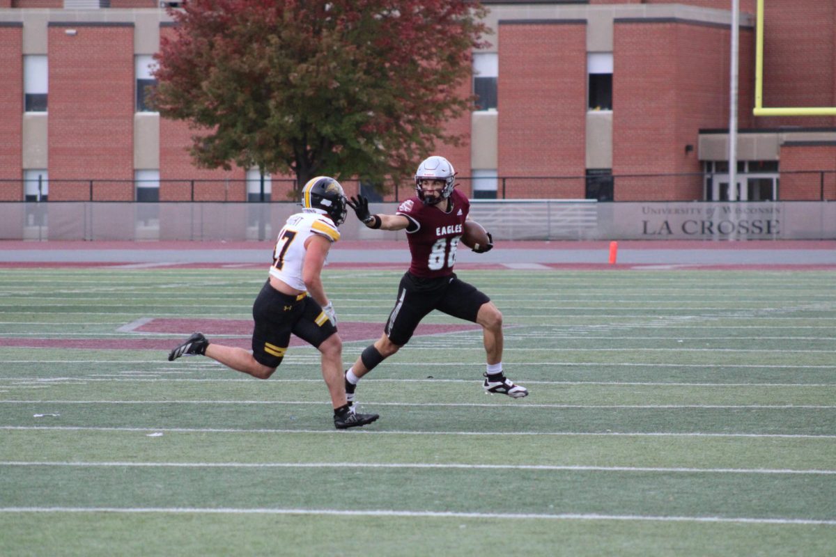 Jack Janke stiff-arming his opponent. Photo by Colin Cronan.