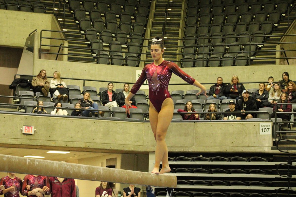UWL gymnast on balance beam. Photo by Colin Cronan. 
