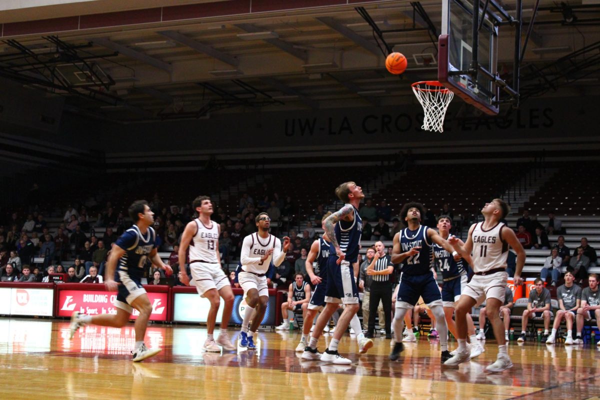 UWL and UW-Stout players reacting to a shot. Photo by Ava Grant. 